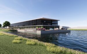 Daglichtimpressie van het bedrijfspand in Bodegraven, strak vormgegeven en direct gelegen aan het water, met parkeerruimte voor de deur en zicht op het logo “BusinessPark”.